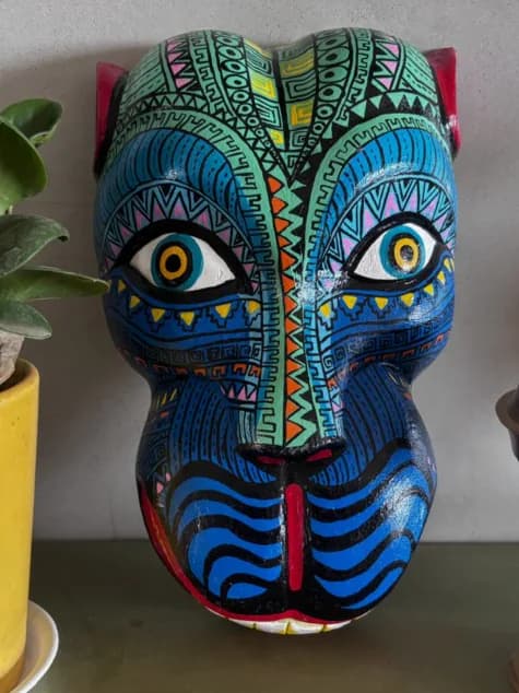 Gomira mask painted with modern geometric patterns